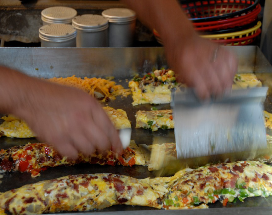 Man's hands making omelets on griddle at Good Eggs in Ephraim, Door County, Wisconsin