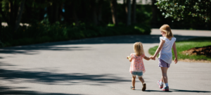 Two girls holding hands and walking at Eagle Harbor Inn in Door County, Wisconsin