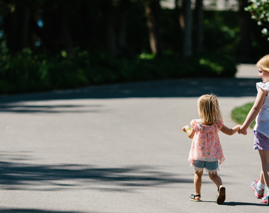 Two girls holding hands and walking at Eagle Harbor Inn in Door County, Wisconsin