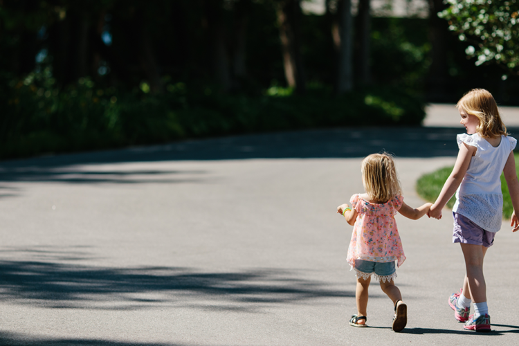 Two girls holding hands and walking at Eagle Harbor Inn in Door County, Wisconsin